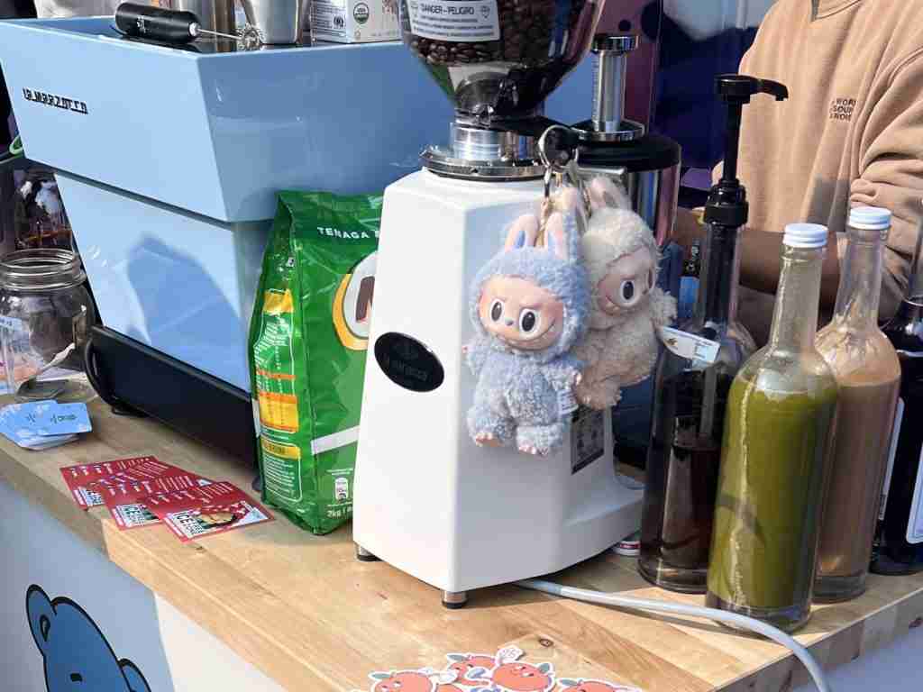 Labubu hanging on coffee grinder